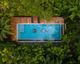 aerial-view-of-swimming-pool-in-the-jungle-of-krab-2022-07-01-03-53-25-utc-1.jpg